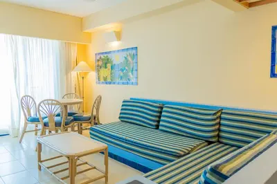 a living room with a couch and a table at Zuana Beach Resort in Santa Marta