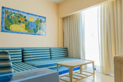 a living room with a couch and a table at Zuana Beach Resort in Santa Marta
