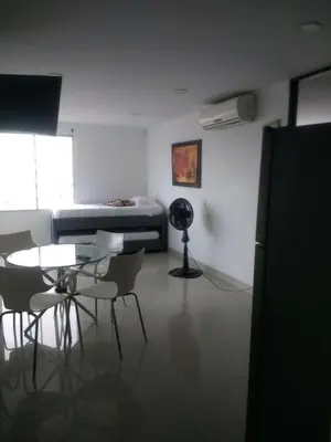 a room with a table and chairs and a bed at 1C5 APARTAMENTO EN CARTAGENA CON BALCON Y VISTA AL MAR, AIRE ACONDICIONADO Y WIFi in Cartagena de Indias