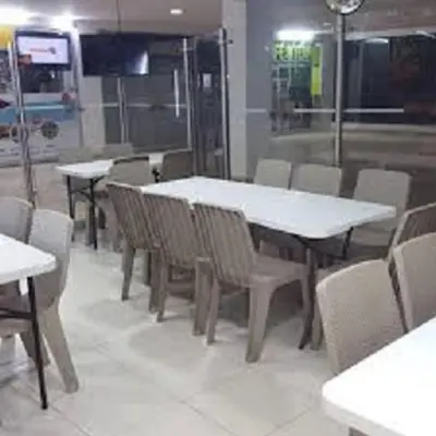a dining room with white tables and chairs at 1C5 APARTAMENTO EN CARTAGENA CON BALCON Y VISTA AL MAR, AIRE ACONDICIONADO Y WIFi in Cartagena de Indias