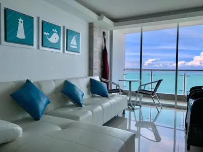 a living room with a couch and a table at apartamento 807 moderno en el laguito, vista al mar in Cartagena de Indias