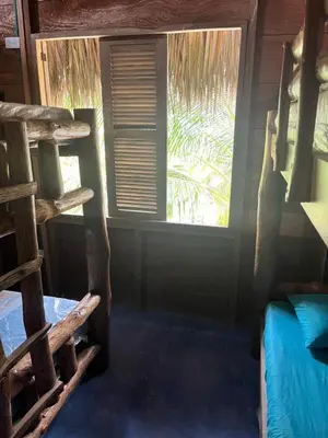 a room with a bunk bed and a window at Rainbow Hostel in San Bernardo del Viento
