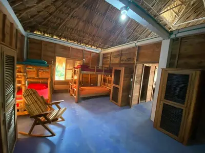 a room with two bunk beds and a chair at Rainbow Hostel in San Bernardo del Viento