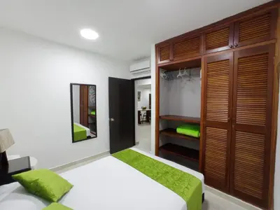 a bedroom with a bed and a closet at APTO INTERIOR in Cartagena de Indias