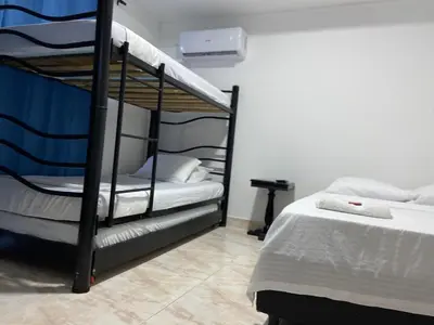 a bedroom with two bunk beds and a tiled floor at Hotel Blue Diamond House in Cartagena de Indias