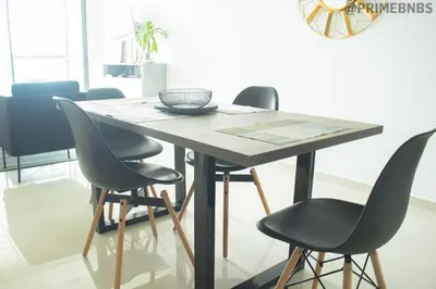 a wooden table with four chairs around it at Brand New - Prime Location For All Budgets - Executive & Luxury in Barranquilla