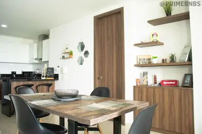 a dining room with a wooden table and chairs at Brand New - Prime Location For All Budgets - Executive & Luxury in Barranquilla