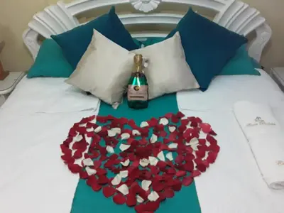 a bed with a heart made out of flowers on it at CASA PACHITA Getsemani in Cartagena de Indias