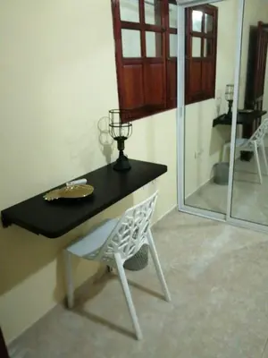 a table and a chair in a room at CASA PACHITA Getsemani in Cartagena de Indias