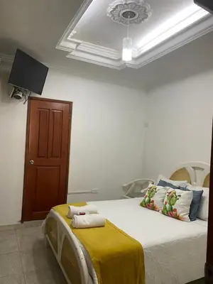 a bedroom with a bed with a yellow blanket at CASA PACHITA Getsemani in Cartagena de Indias
