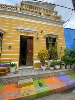 a yellow house with a rainbow curb in front of it at CASA PACHITA Getsemani in Cartagena de Indias