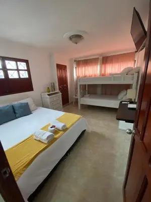 a bedroom with a large bed with two bunk beds at CASA PACHITA Getsemani in Cartagena de Indias