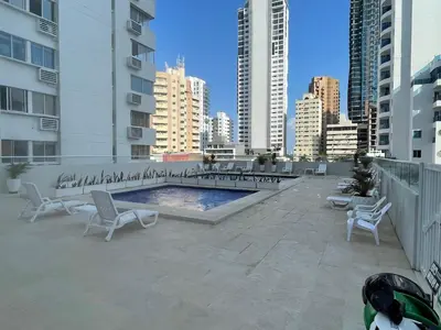 a patio with chairs and a pool in a city at STUDIO DELFINES / BOCAGRANDE in Cartagena de Indias
