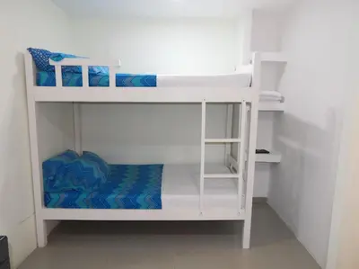 a white bunk bed in a small room at STUDIO DELFINES / BOCAGRANDE in Cartagena de Indias