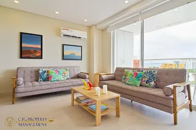 a living room with two couches and a coffee table at Martinique Cartagena, Beautiful 1 & 2 Bedroom Apartments in Cartagena de Indias