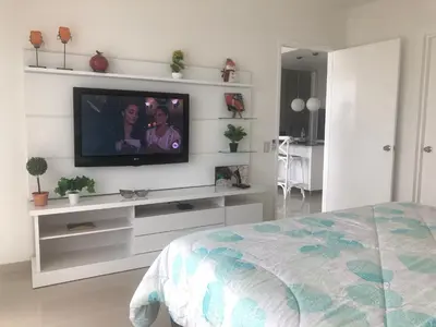 a bedroom with a flat screen tv on a wall at Hermoso apartamento con todas las comodidades acceso directo a la playa ubicado en el edificio Morros Epic in Cartagena de Indias