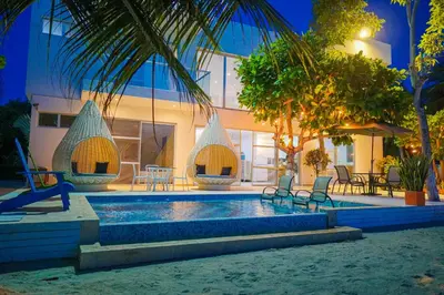 a swimming pool in front of a building at Quinta del Mar La Joya in Tolú