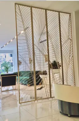 a room with a large glass wall with a table at Hotel OR Suites in Barranquilla