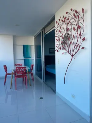 a dining room with a table and red chairs at Playa Bello Horizonte, vista preciosa in Gaira