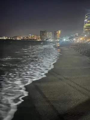 a beach at night with a city in the background at Playa Bello Horizonte, vista preciosa in Gaira
