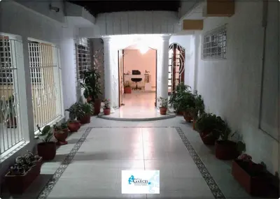 a hallway with potted plants in a building at HOTEL CASA GARCES in Cartagena de Indias