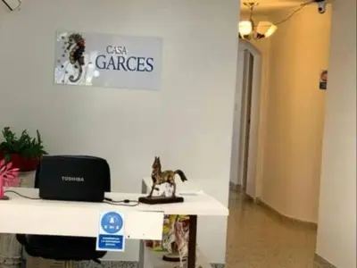 an office with a desk with a laptop on it at HOTEL CASA GARCES in Cartagena de Indias