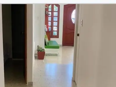 a view of a hallway with a red door at HOTEL CASA GARCES in Cartagena de Indias