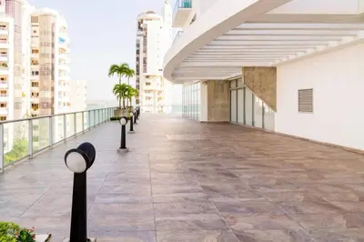 a walkway in a building with buildings in the background at Cómodo moderno apto en Bocagrande a 2' de la playa in Cartagena de Indias
