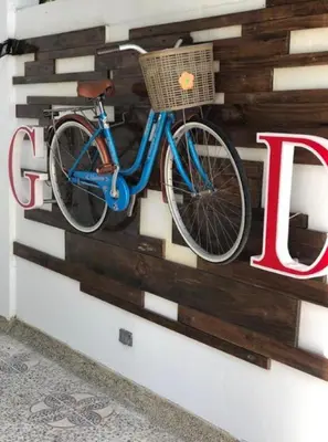 a blue bike is hanging on a wall at ibis budget Barranquilla in Barranquilla