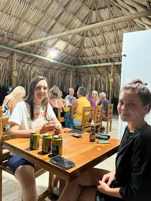 two girls sitting at a table in a restaurant at Hotel Las Casitas De Mar Adentro in Isla Grande