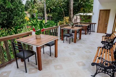 a row of tables and chairs on a patio at Hotel Restaurante Selva Negra in Turbaco