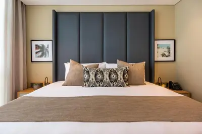 a bedroom with a large bed with a large headboard at Oz Hotel Luxury in Cartagena de Indias