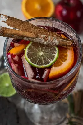 a glass of mulled sangria with lime and cinnamon sticks at Oz Hotel Luxury in Cartagena de Indias