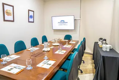 a conference room with a long table and chairs at Howard Johnson by Wyndham Barranquilla Versalles in Barranquilla
