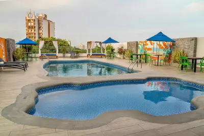 a swimming pool on the roof of a building at Howard Johnson by Wyndham Barranquilla Versalles in Barranquilla