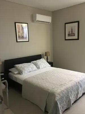 a bedroom with a large bed with a white comforter at Martinique1621 in Cartagena de Indias