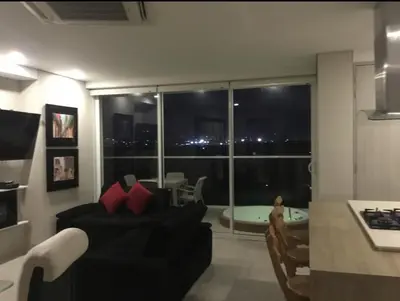 a living room with a couch and a large window at Martinique1621 in Cartagena de Indias