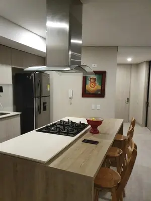 a kitchen with a kitchen island with a stove top at Martinique1621 in Cartagena de Indias