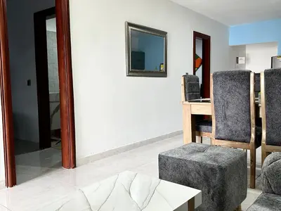 a living room with a chair and a table at Apartamento en Coveñas cómodo y acogedor in Coveñas