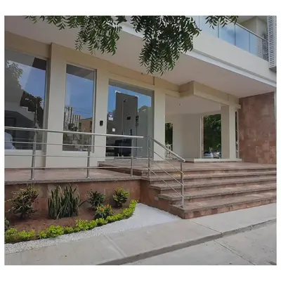 a large house with glass windows and stairs at Apartahotel Plaza de ángel 74 in Barranquilla