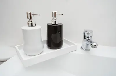 two black and white soap dispensers on a white sink at Casa Franco Hotel in Cartagena de Indias