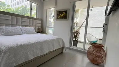 a bedroom with a bed and a large window at Spiaggia Morros Direct Beach Access in Cartagena de Indias