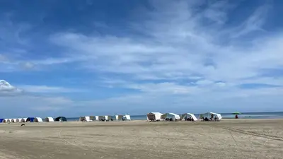 a group of tents on a beach with the ocean at Spiaggia Morros Direct Beach Access in Cartagena de Indias