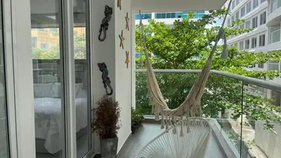 a hammock on the balcony of a house at Spiaggia Morros Direct Beach Access in Cartagena de Indias