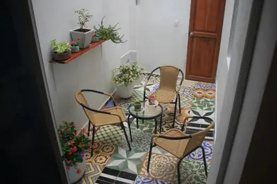 a room with a table and chairs on a tile floor at Casa St James in Cartagena de Indias