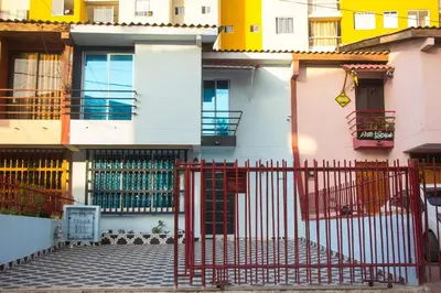 a building with a red gate in front of it at Casa St James in Cartagena de Indias