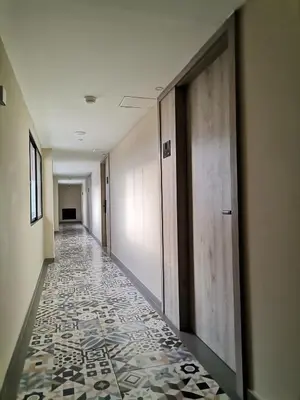an empty hallway with a tile floor in a building at Berilo Deluxe Apartahotel in Barranquilla