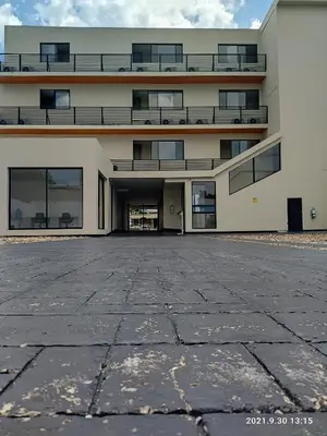 an empty parking lot in front of a building at Berilo Deluxe Apartahotel in Barranquilla