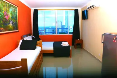 a small room with two beds and a window at Loft sea view 11C air and wifi in Cartagena de Indias