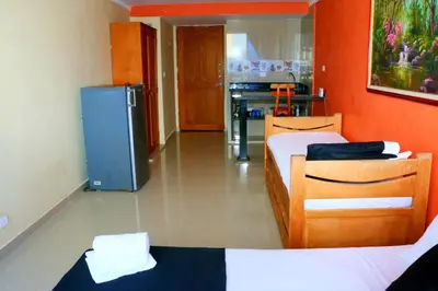 a room with two beds and a refrigerator at Loft sea view 11C air and wifi in Cartagena de Indias